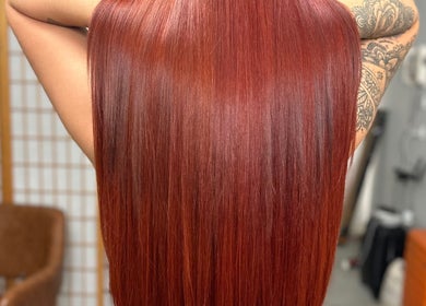 Sleek red hair showcased at Hair by Wilz, Auckland, Auckland, NZ. Discover expert hair styling services.