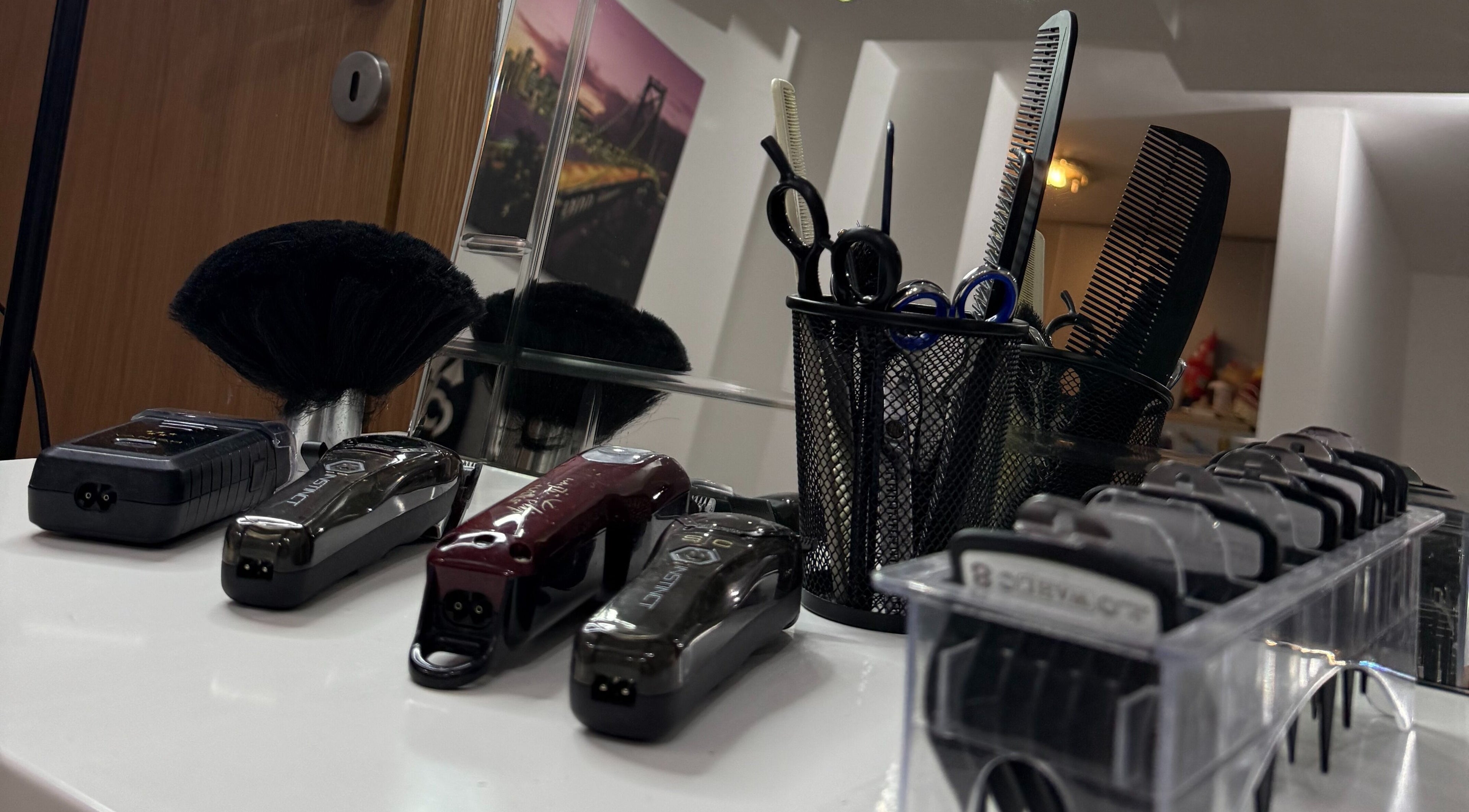 Professional hair clippers and scissors setup at Prota Barbershop, Beograd, RS, showcasing top-notch grooming tools.