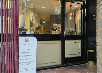 Entrance of Health and Beauty Clinic in London, England, GB. Sign advertises facials, mesotherapy, and more.