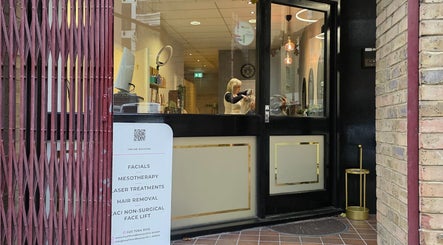 Entrance of Health and Beauty Clinic in London, England, GB. Sign advertises facials, mesotherapy, and more.