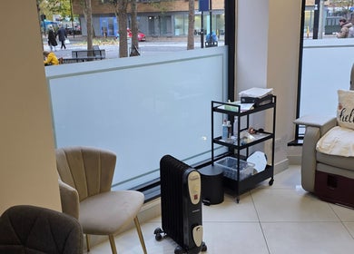 Relaxing lounge area at Health and Beauty Clinic, London, England, GB with cozy chairs and beauty products.