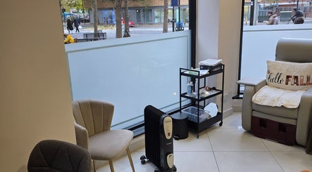 Relaxing lounge area at Health and Beauty Clinic, London, England, GB with cozy chairs and beauty products.
