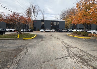 Entrance view of Artistry Nail Lounge, Louisville, Kentucky. Parking area and autumn trees visible.