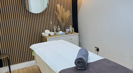Serene treatment room at The Spa Culture, London, England, GB, featuring a massage table and calming decor.