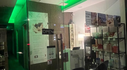 Entrance of The Spa Culture in London, England, GB, showcasing a calming interior with green lighting and wellness products.