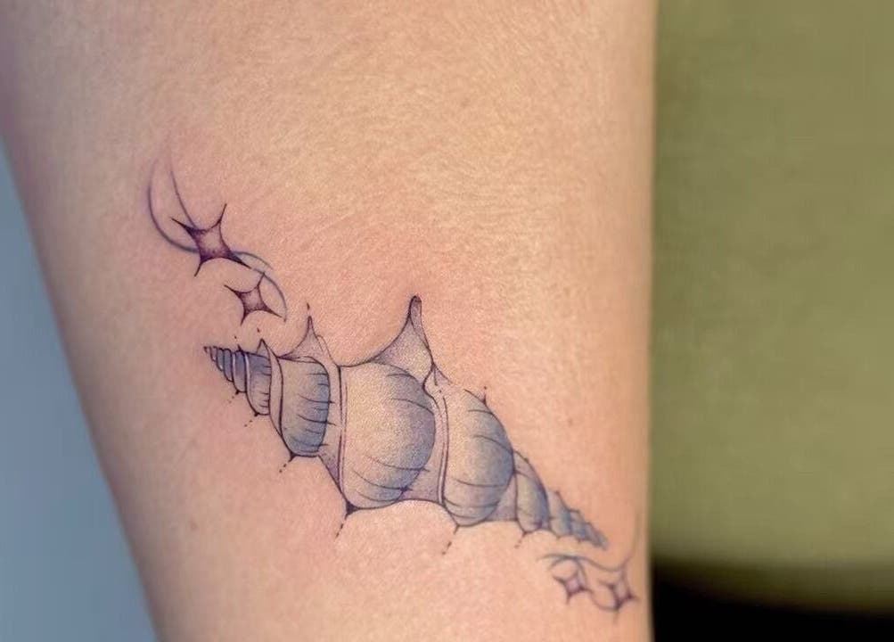 Detailed seashell tattoo design at TEEMOOINK TATTOO, Surry Hills, New South Wales, AU.