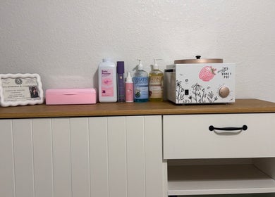 Waxing supplies at Berry Smooth Waxing Co., Dickinson, Texas, US, including lotions and a wax warmer.