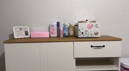 Waxing supplies at Berry Smooth Waxing Co., Dickinson, Texas, US, including lotions and a wax warmer.