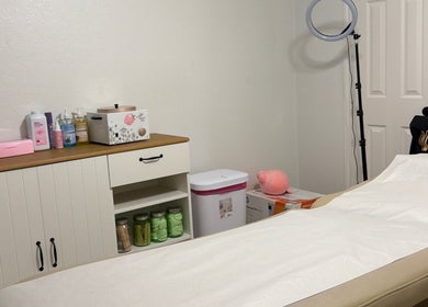 Cozy waxing room at Berry Smooth Waxing Co. in Dickinson, Texas, US, featuring a treatment bed and supplies.