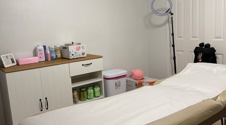 Cozy waxing room at Berry Smooth Waxing Co. in Dickinson, Texas, US, featuring a treatment bed and supplies.