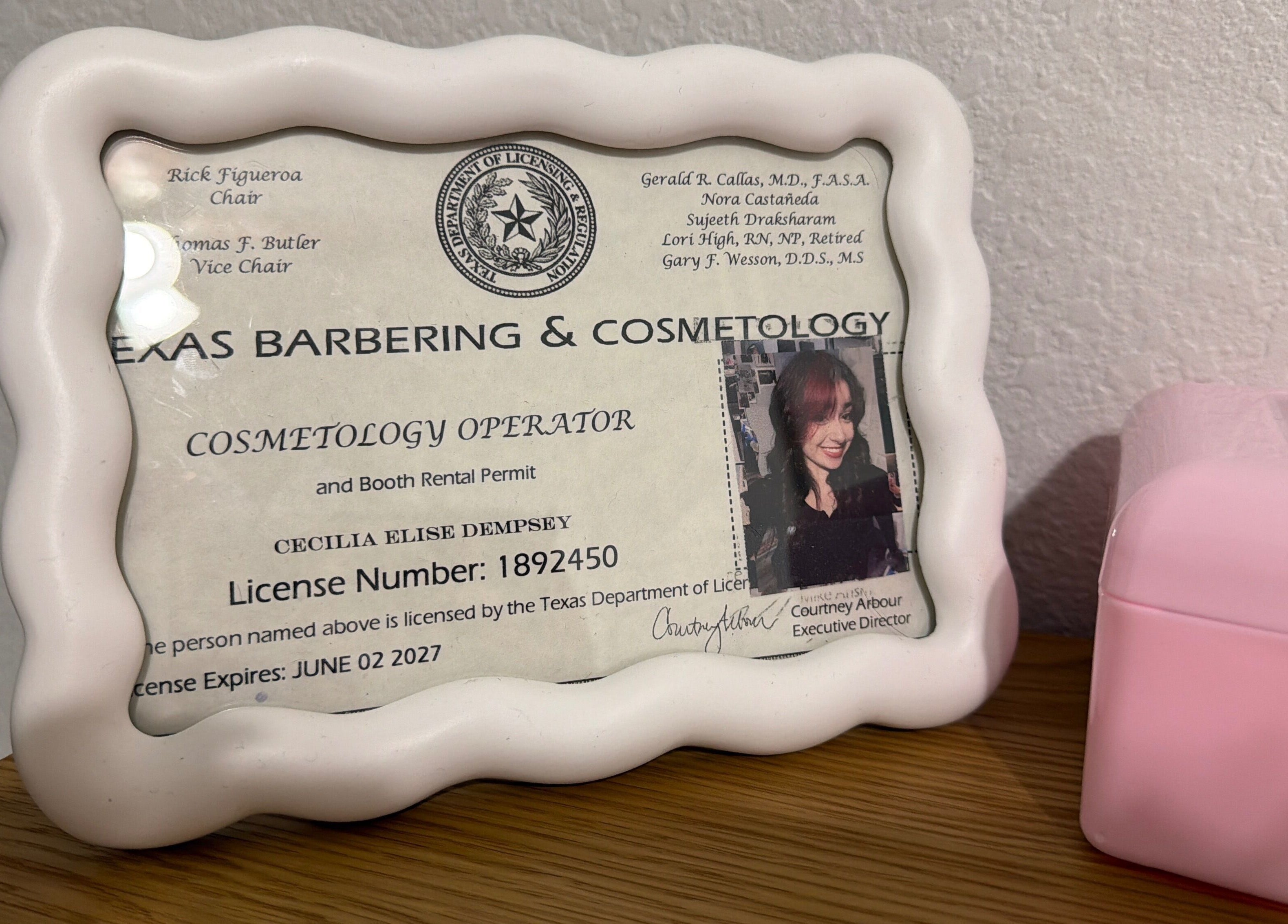 Framed cosmetology license at Berry Smooth Waxing Co., Dickinson, Texas, US.