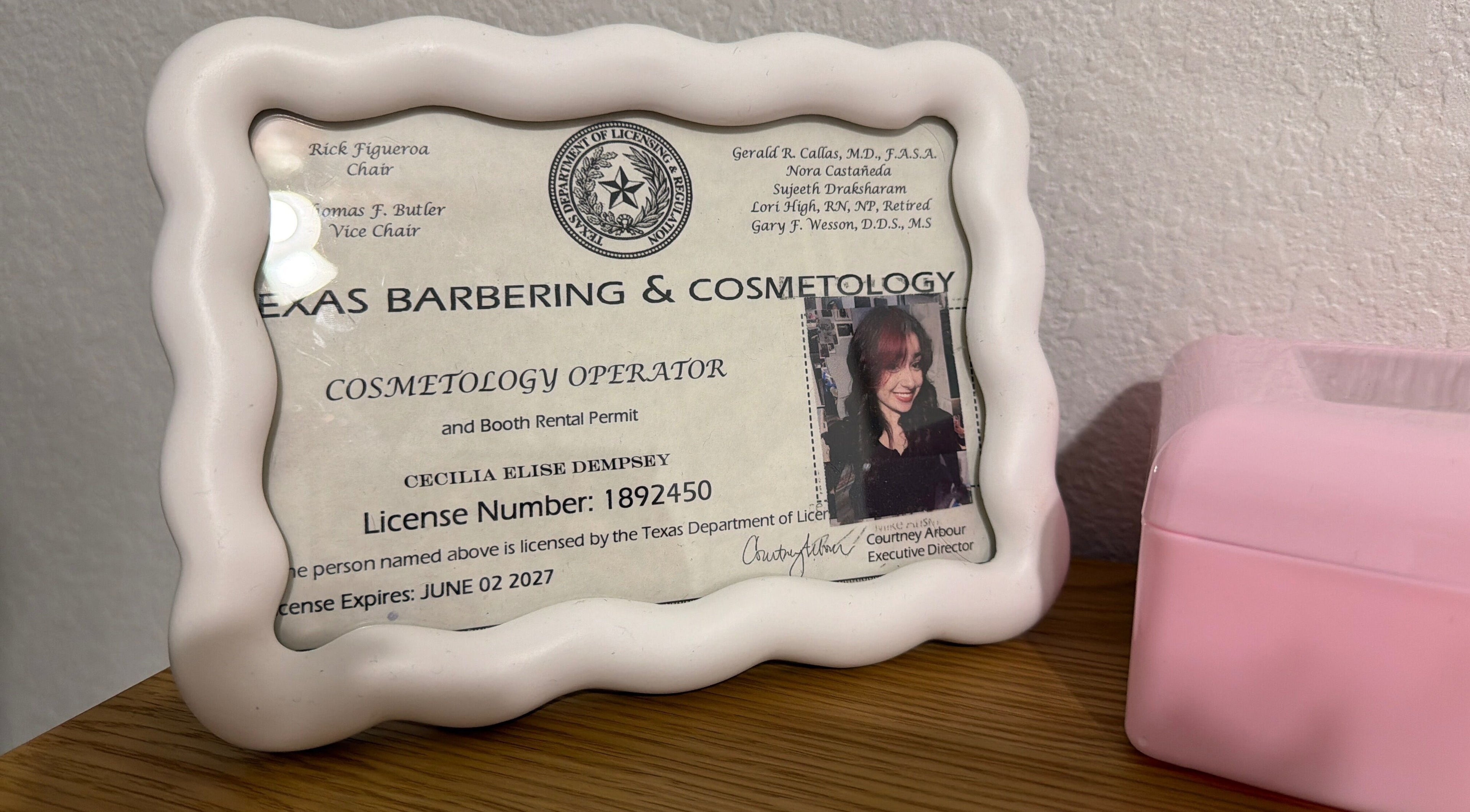 Framed cosmetology license at Berry Smooth Waxing Co., Dickinson, Texas, US.
