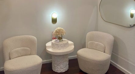 Elegant seating area at Siren Cosmetic Clinic, Perth, Western Australia, AU, featuring plush chairs and decor.