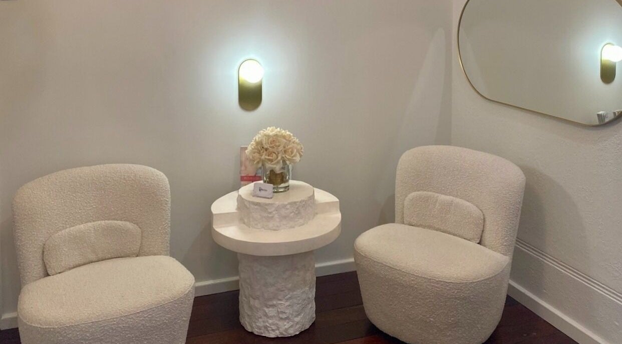 Elegant seating area at Siren Cosmetic Clinic, Perth, Western Australia, AU, featuring plush chairs and decor.