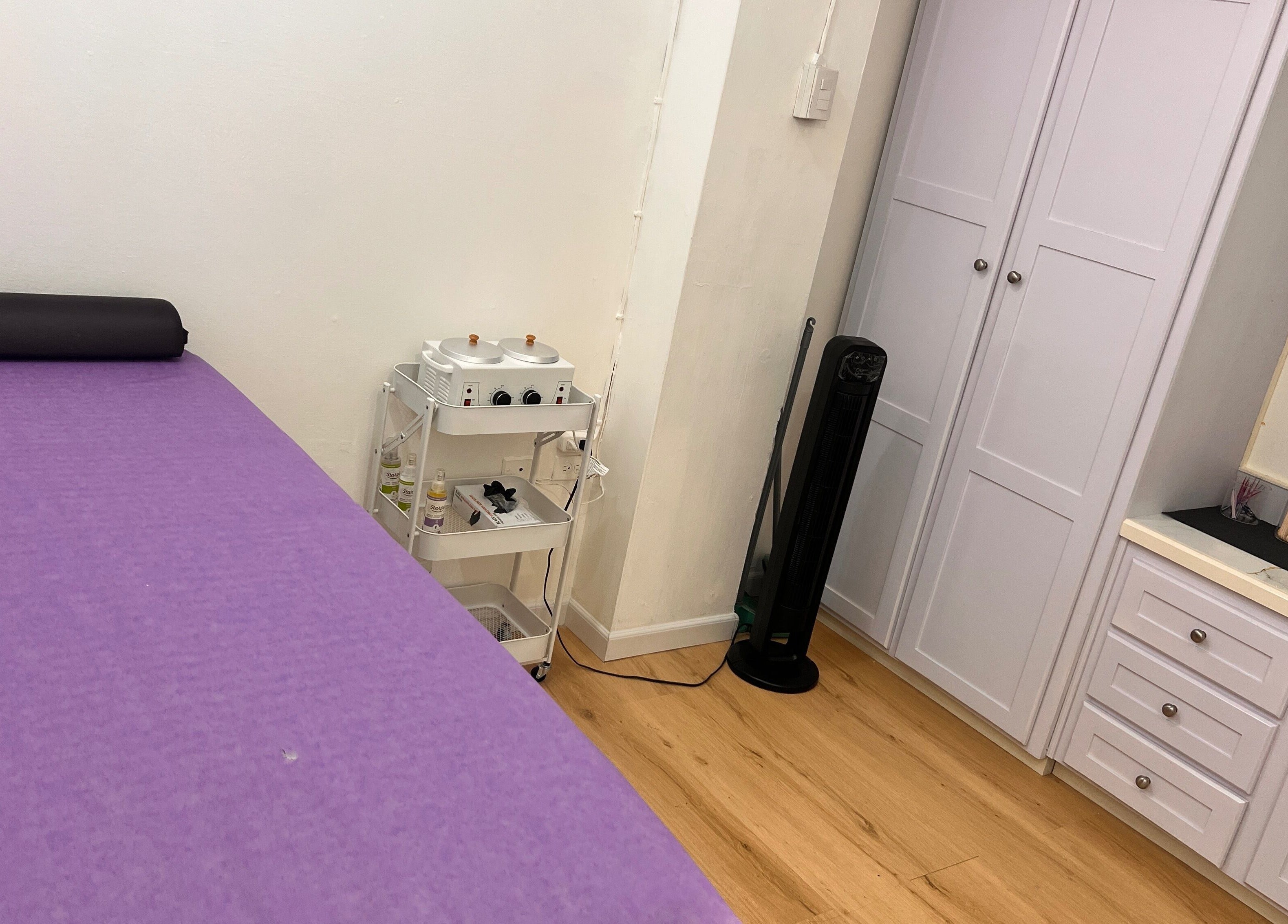 Tranquil purple massage room at ACEluxeluminance, Port Of Spain, TT, perfect for relaxation and wellness therapies.