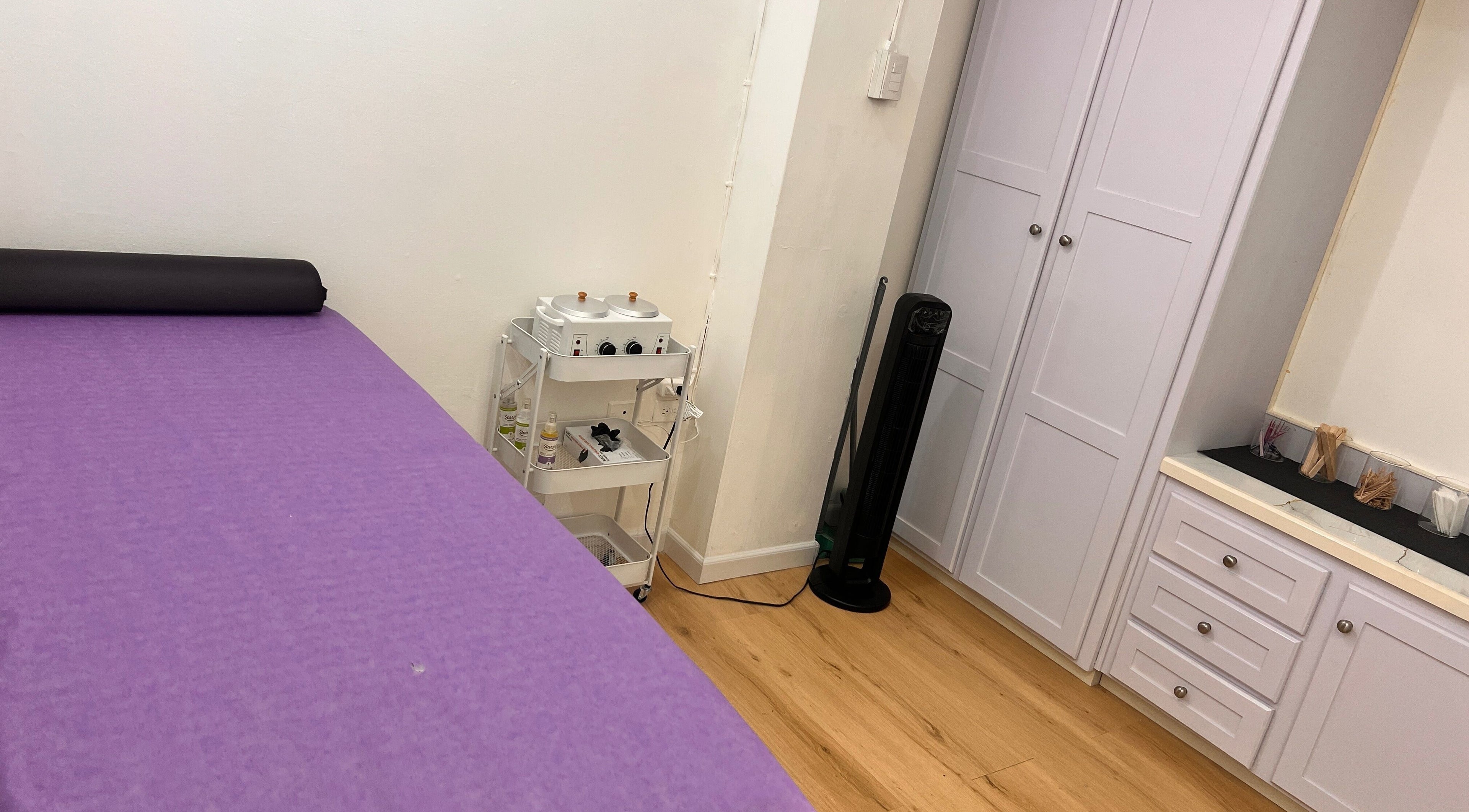 Tranquil purple massage room at ACEluxeluminance, Port Of Spain, TT, perfect for relaxation and wellness therapies.