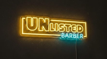 Bright neon Unlisted Barber SG sign, glowing warmly in Singapore, Singapore, SG.