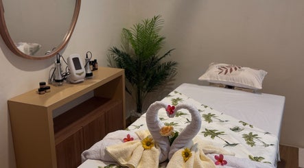 Relaxing treatment room at reSPAwn Spa Bali, Kec. Kuta Utara, Bali, ID with towels and decor.