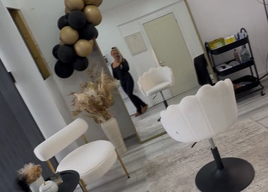 Modern salon interior at Beauty&lengths by aim, Stoke-on-Trent, England, GB with elegant chairs and decor.