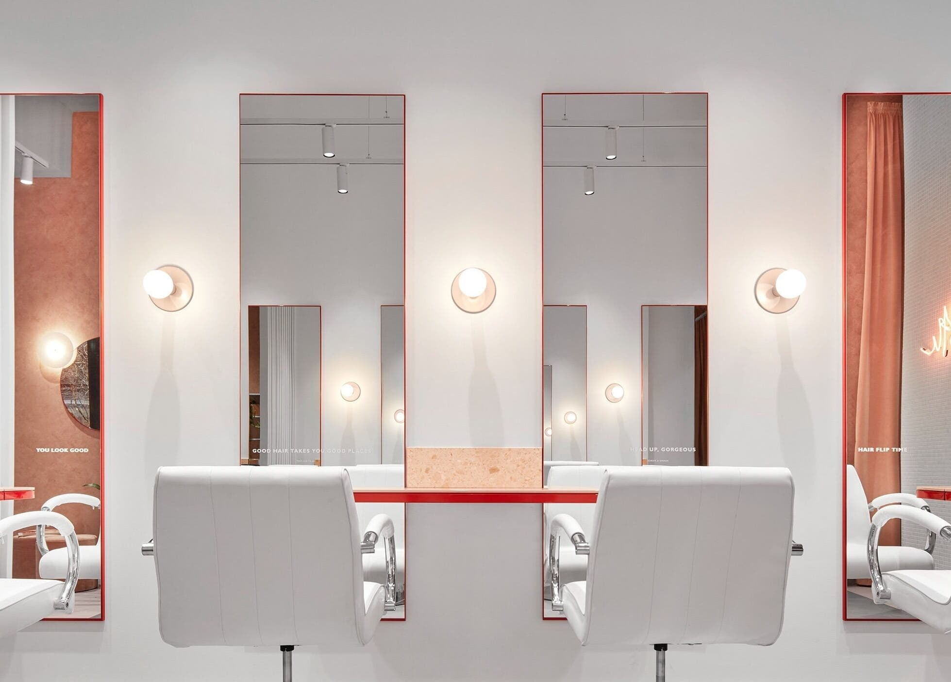 Stylish salon interior at The Blow Australia, Melbourne, Victoria, AU with modern white chairs and mirrors.