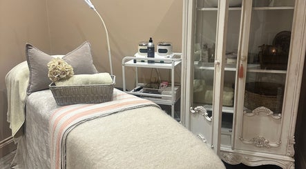 Relaxing treatment room at Blushington Beauty, Poole, England, GB with a plush bed and elegant decor.