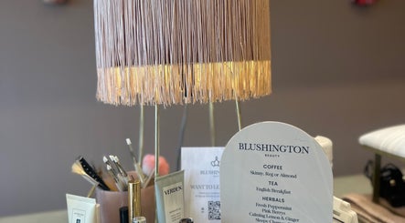 Chic lamp and menu at Blushington Beauty, Poole, England, GB showcasing elegant decor and offerings.