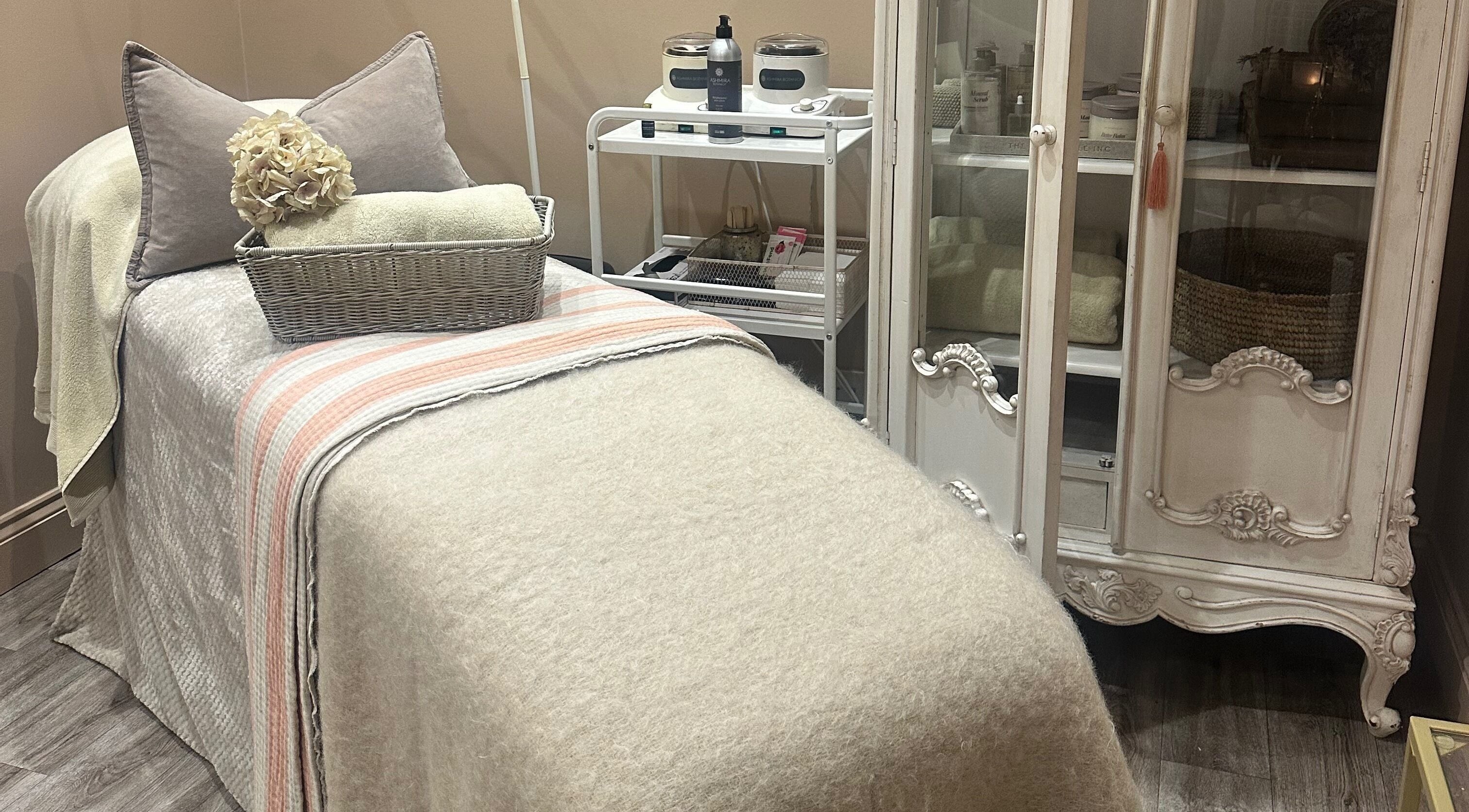 Relaxing treatment room at Blushington Beauty in Poole, England, GB showcasing cozy decor and serene ambiance.