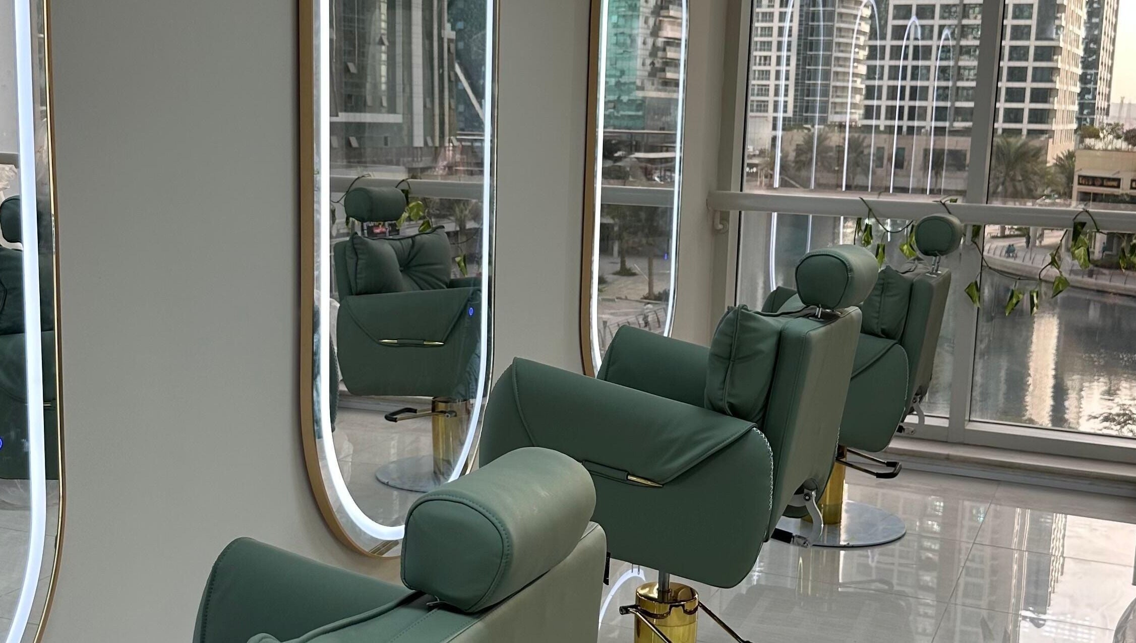 Inside Jazz Loc Studio at 2nd Floor - #210, Dubai, AE, featuring plush green chairs and sleek mirrors.