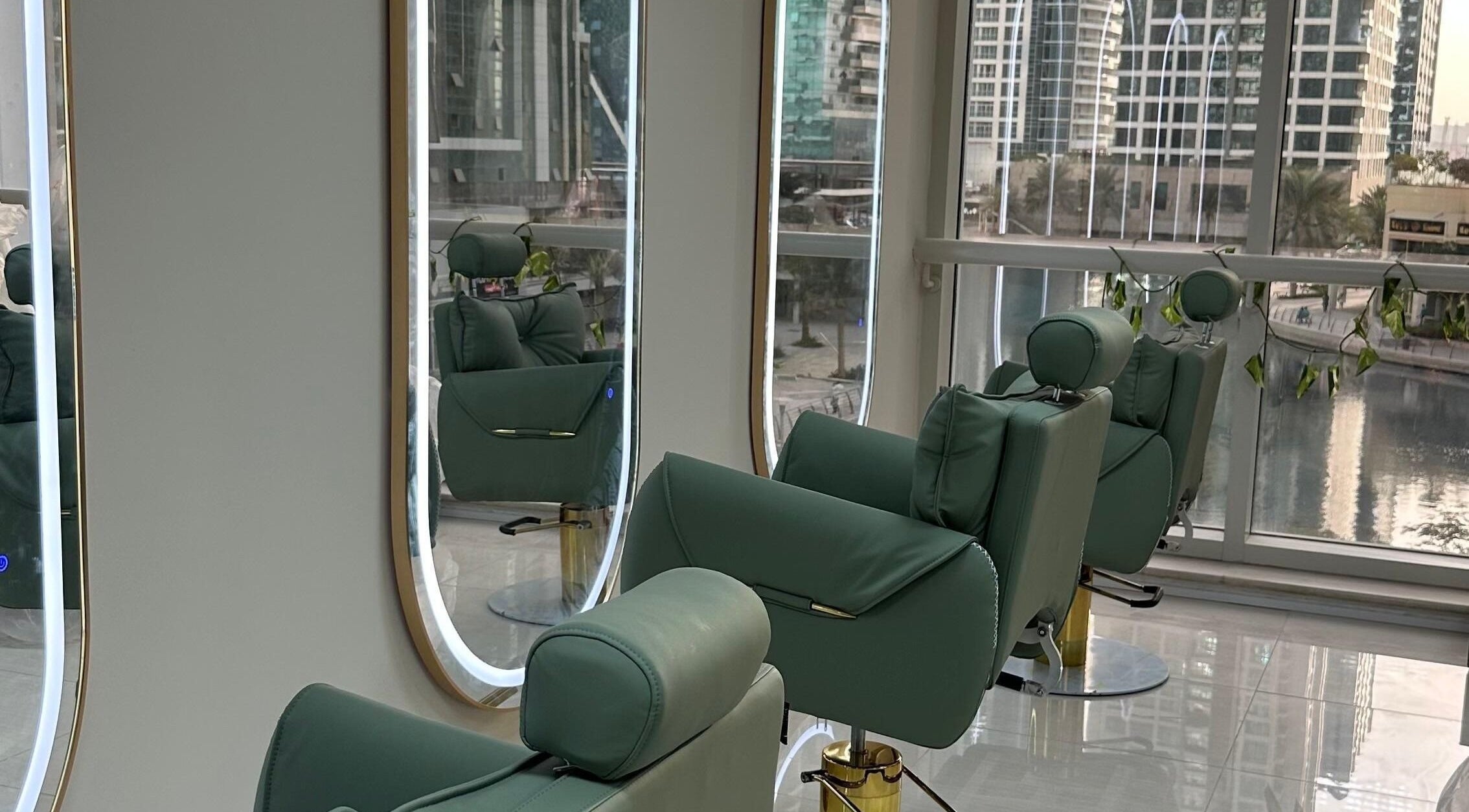 Inside Jazz Loc Studio at 2nd Floor - #210, Dubai, AE, featuring plush green chairs and sleek mirrors.