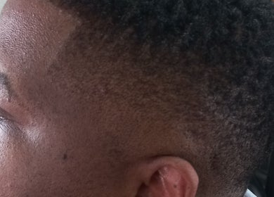 Close-up of a classic fade haircut at Classic Touch Barber, Sandton, Gauteng, ZA.
