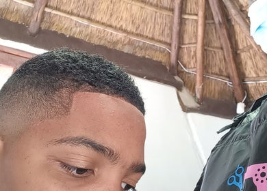 Close-up of precise haircut at Classic Touch Barber, Sandton, Gauteng, ZA, showcasing a sharp fade.