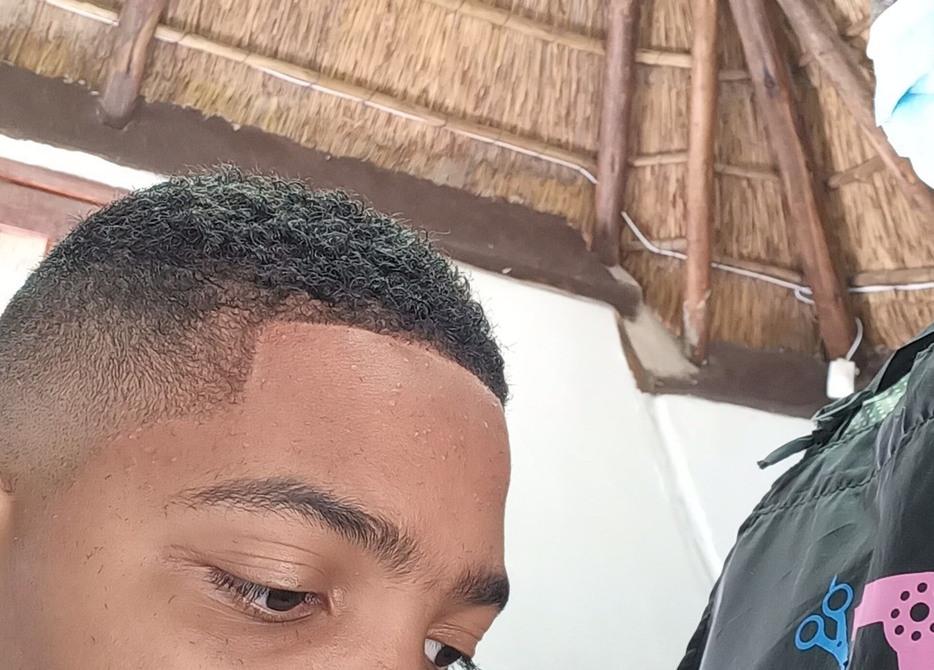 Classic Touch Barber in Sandton, Gauteng, ZA provides a precision haircut in a rustic setting.