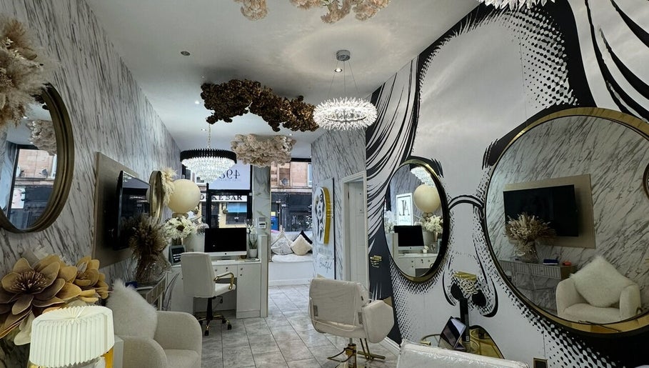 Chic interior of HairByD salon, Glasgow, Scotland, GB, featuring elegant decor and modern styling stations.