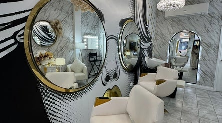 Elegant interior of HairByD, Glasgow, Scotland, GB showcasing stylish mirrors and plush seating.