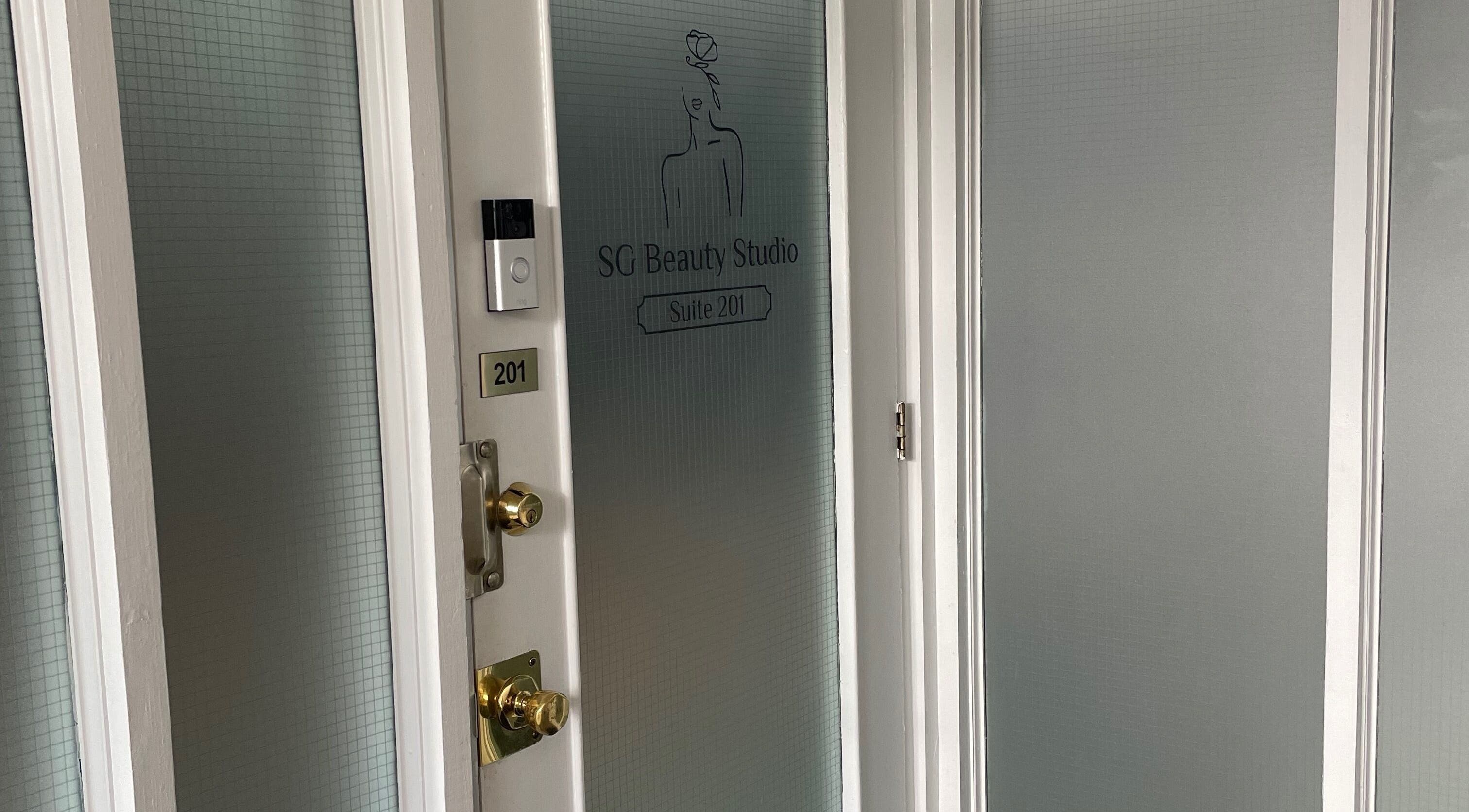 Entrance of SG Beauty Studio at The Wink Room, Gatineau, Québec, CA featuring frosted glass doors.