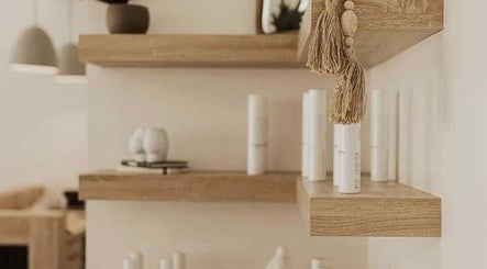 Chic wooden shelves at Restore & Renew, Boston, Massachusetts, US, showcasing beauty products in a serene ambiance.
