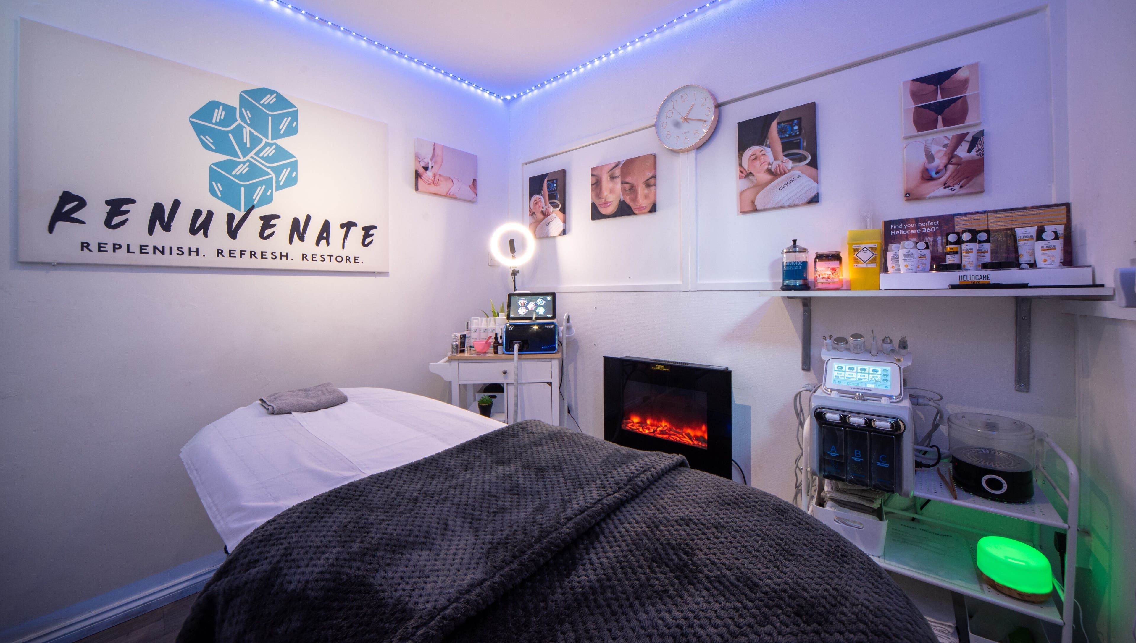 Relaxing spa room at Renuvenate Welling, England, GB with a cozy massage table and calming decor.