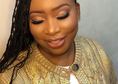 Woman with glowing makeup at MAZmerise Beauty studio, Berea, Kwazulu-natal, ZA. Styled braids complement her look.