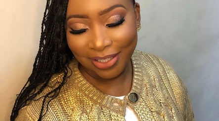 Woman with glowing makeup at MAZmerise Beauty studio, Berea, Kwazulu-natal, ZA. Styled braids complement her look.