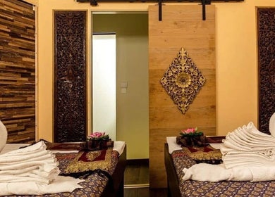 Elegant massage room at Wiphaspa2 Thai Massage, Paris, with towel swans and intricate decor.