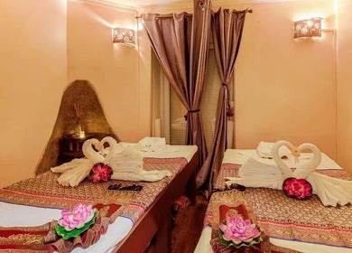 Relaxing massage beds at Wiphaspa2 Thai Massage, Paris, Île-de-France, FR with elegant swan towel decor.