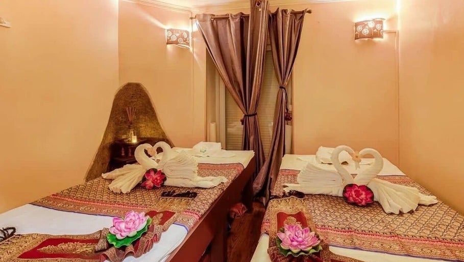 Elegant massage beds with towel swans at Wiphaspa2 Thai Massage in Paris, Île-de-France, FR.