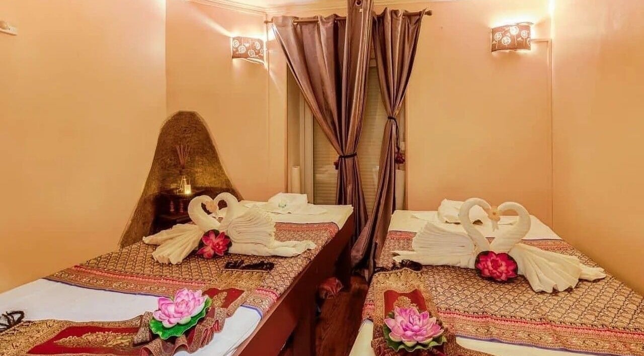 Elegant massage beds with towel swans at Wiphaspa2 Thai Massage in Paris, Île-de-France, FR.