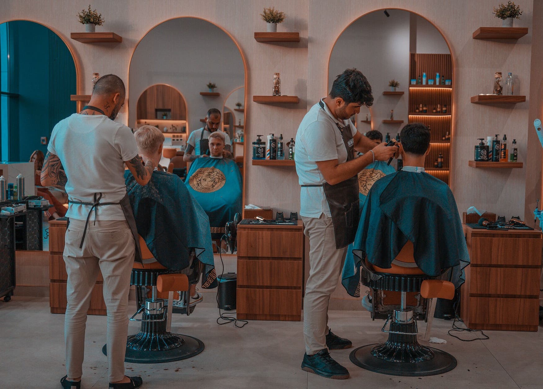 Interior of Bebek Gents Salon L.L.C in Dubai, AE showing barbers styling clients in a chic setting.