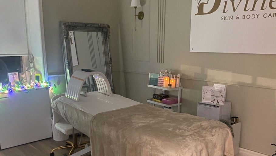 A serene treatment room at Divine Skin and Body Care in Glasgow, Scotland, GB showcasing a cozy bed and elegant decor.