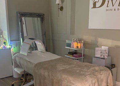A serene treatment room at Divine Skin and Body Care in Glasgow, Scotland, GB showcasing a cozy bed and elegant decor.