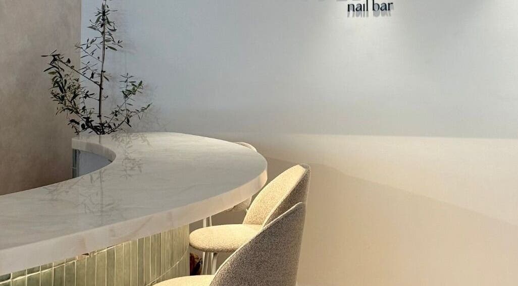 Elegant interior of Dudleys nail bar in Auckland, Auckland, NZ with curved seating and minimalist decor.
