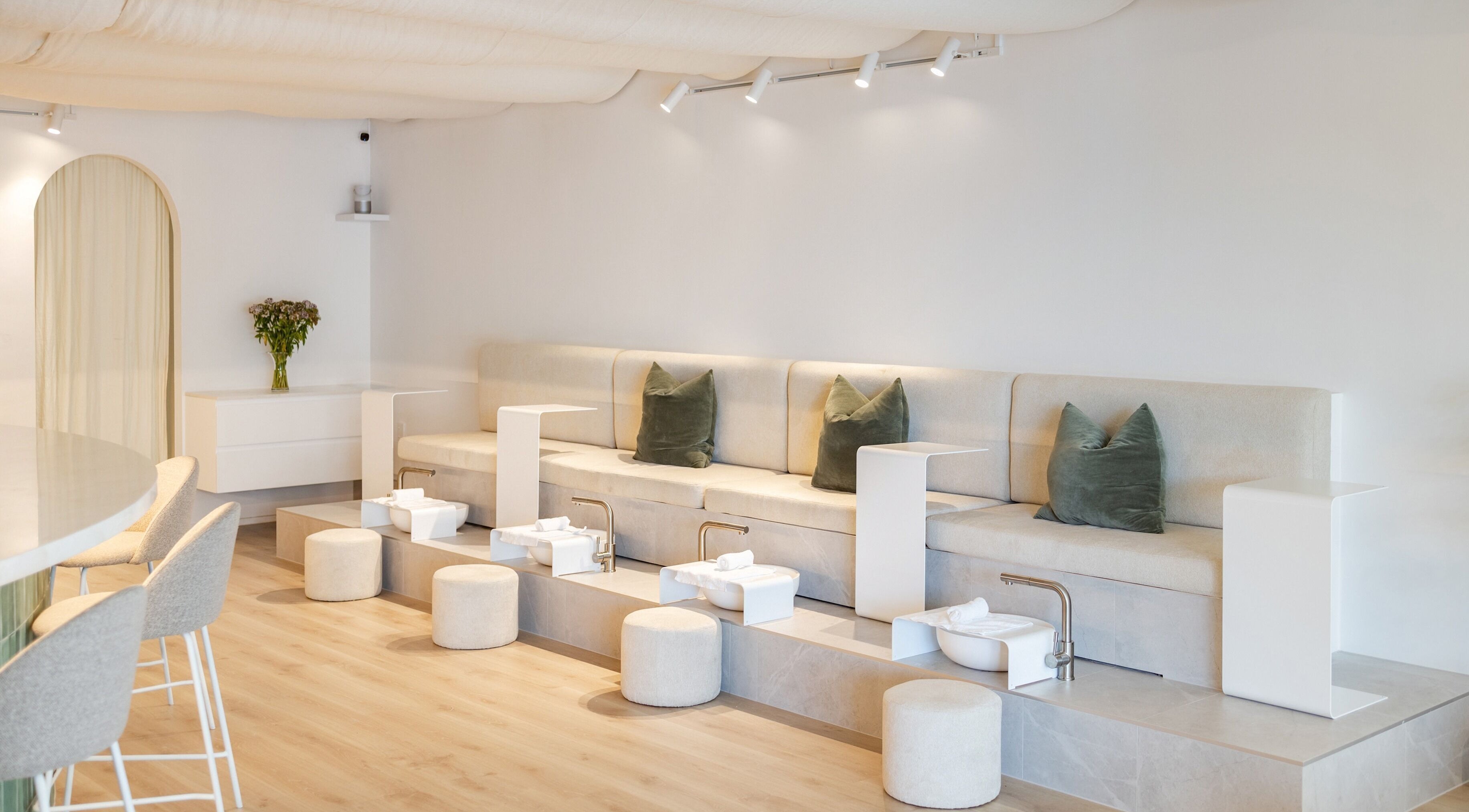 Elegant spa setting at Dudleys, Auckland, NZ featuring plush seating and foot baths for ultimate relaxation.