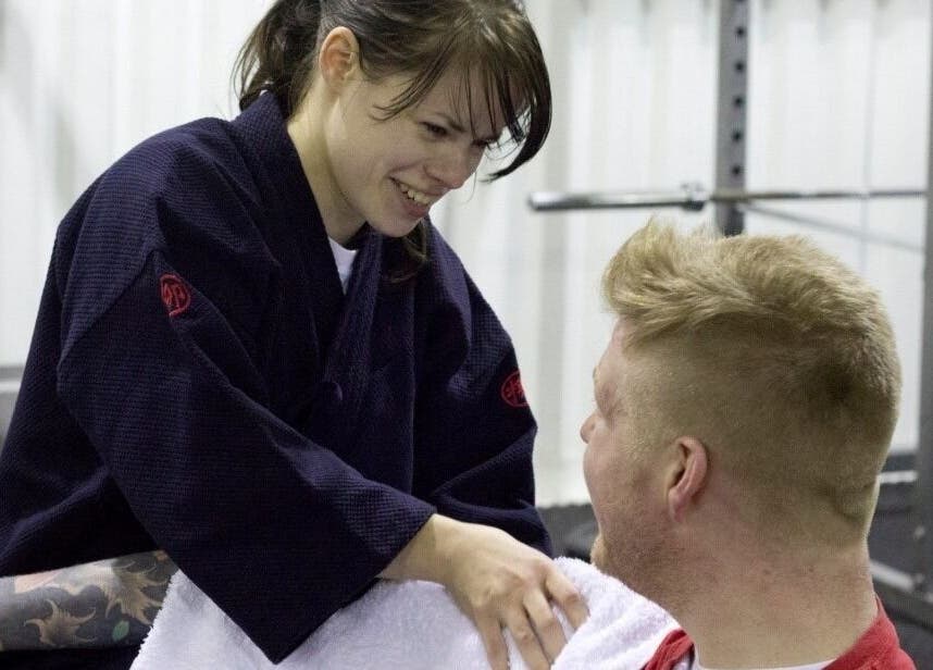Practitioner smiling at client in Astbury Acutherapy, Congleton, England, GB.