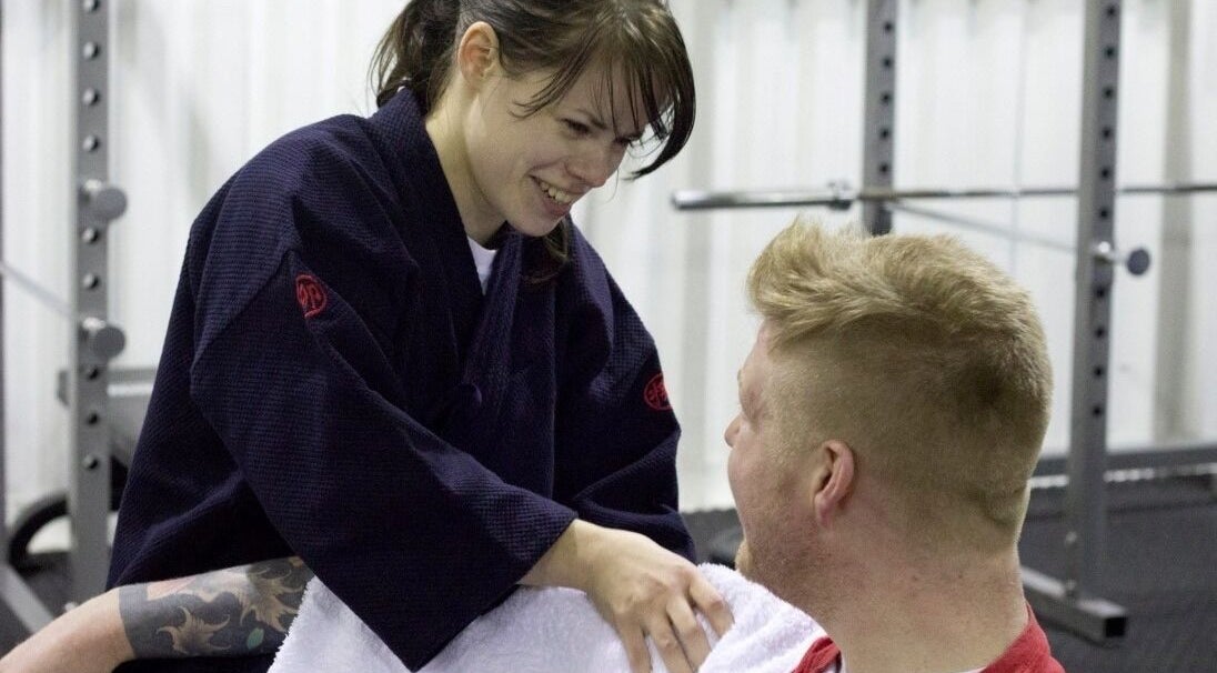 Practitioner smiling at client in Astbury Acutherapy, Congleton, England, GB.